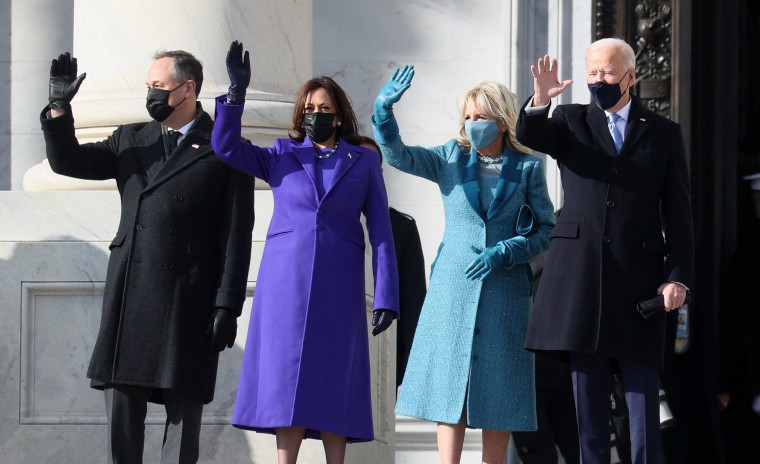 Doug Emhoff, Kamala Harris, Jill Biden and Joe Biden waved from the steps from the U.S. Capitol. 