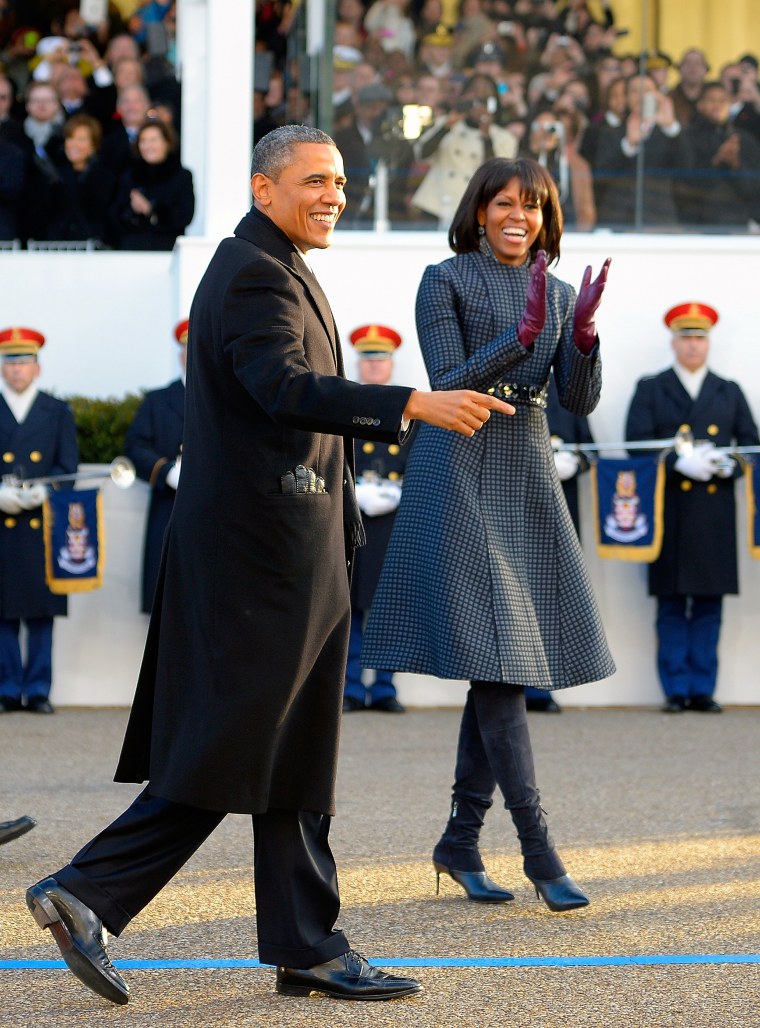 President Barack Obama, left, and his wife Michelle walk along Pennsylvania Ave in front of the Reviewing stand after he was sworn into office  for his second term.
