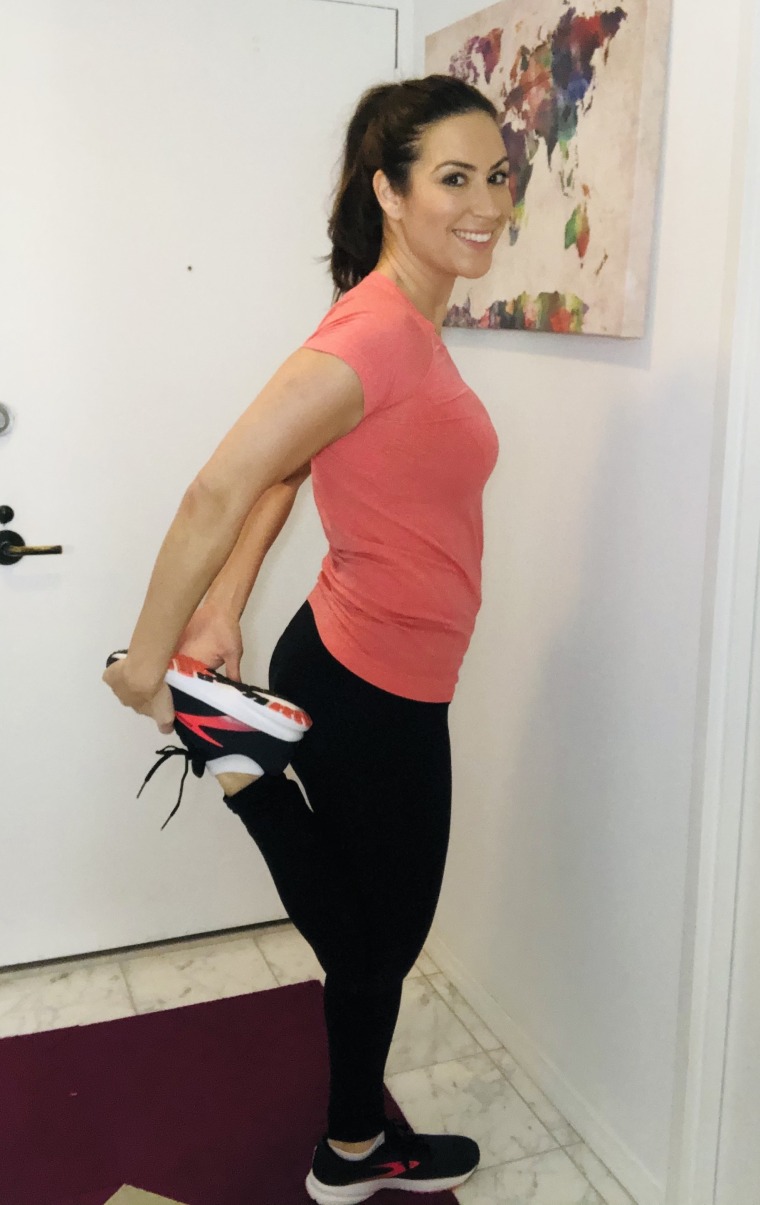 Fitness woman stretch legs doing warm-up before run workout