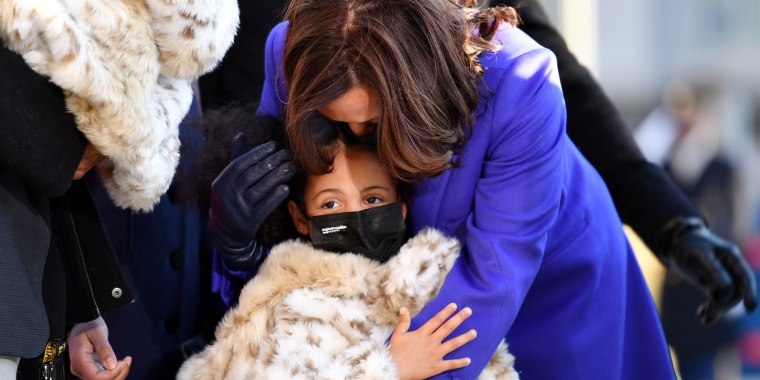 U.S. Vice President Kamala Harris walks the abbreviated parade route with her great niece Amara