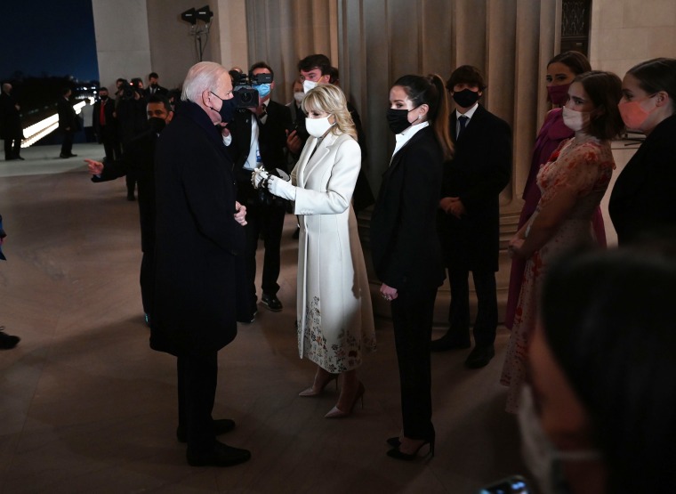 US President Joe Biden stands with First Lady Jill Biden, daughter Ashley  and grandchildren as he prepares to speak during the "Celebrating America" inaugural program at the Lincoln Memorial in Washington, DC,