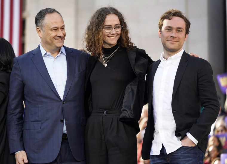Emhoff poses with her dad and brother at a campaign rally for Harris in 2019. 