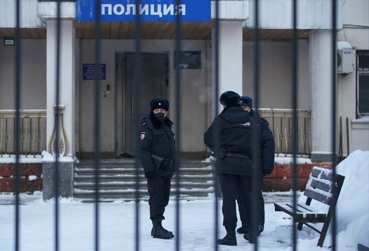 Image: Police officers stand outside a police station where detained Russian opposition leader Navalny is being held, in Khimki