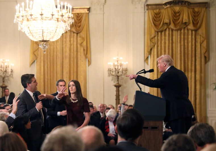 Image: A White House staff member reaches for the microphone held by CNN's Jim Acosta as he questions U.S. President Donald Trump during a news conference in Washington