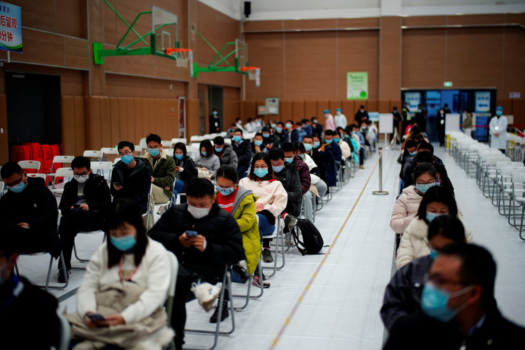 Image: People sit at a vaccination site in Shanghai, China after receiving a dose of a Covid-19 vaccine.