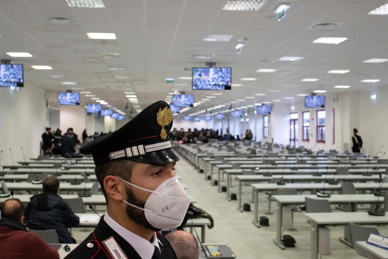 Image: A Carabinieri police officer wearing a face mask stands guard as a general view shows a special courtroo