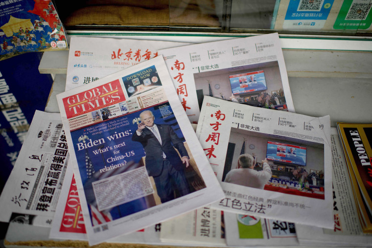 Image: Newspaper front pages at a news stand in Beijing on Nov. 9.