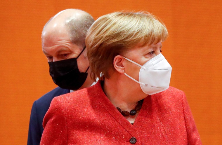 Image: German Chancellor Angela Merkel and German Finance Minister and Vice-Chancellor Olaf Scholz wear protective face masks at the chancellor's offices in Berlin on Wednesday.