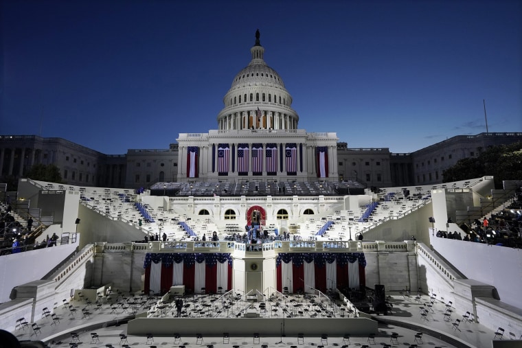 Image: The U.S. Capitol and stage are lit as the sun begins to rise before events get underway before the 59th Presidential Inauguration