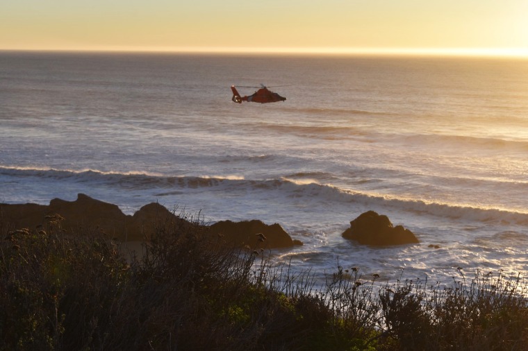 Emergency workers look for a child who was swept out to sea at Cowell Ranch State Beach in San Mateo County, Calif., on Jan. 18, 2020.