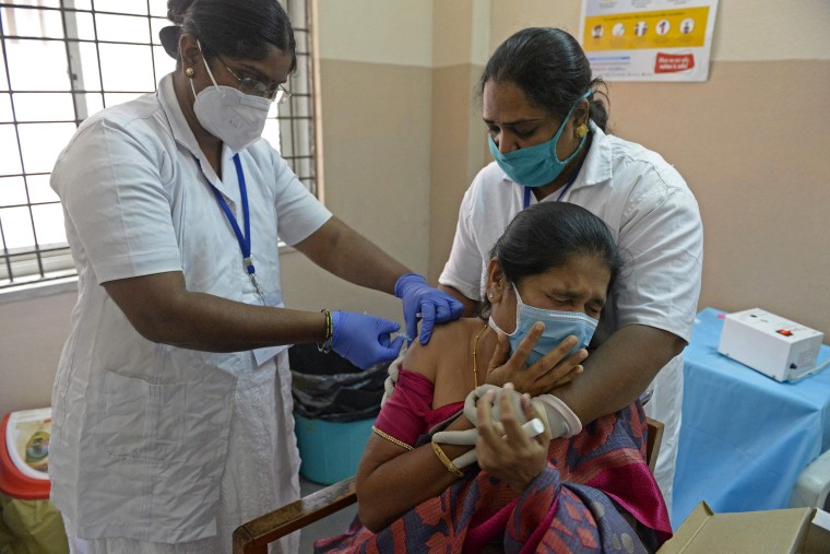 Image: A member of medical staff reacts as a health worker inoculates her with a Covid-19 coronavirus vaccine at a government hospital in Hyderabad