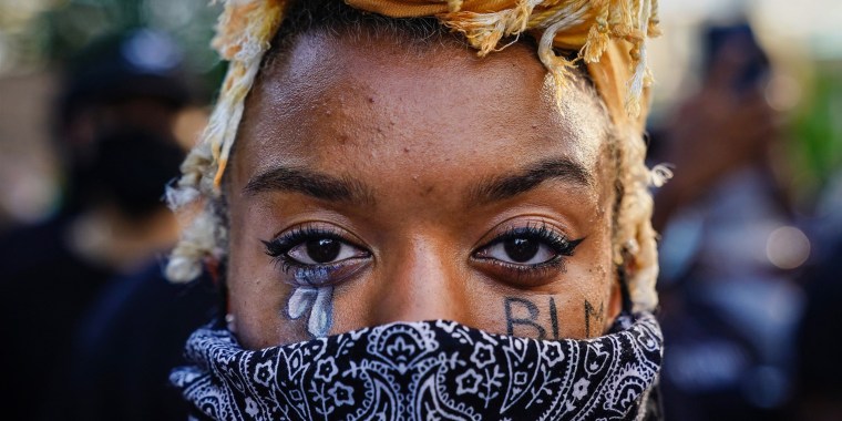 A woman with 'BLM' written on her cheek poses during a demonstration on May 31, 2020 in Atlanta.
