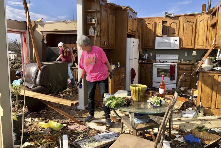 Patti Herring sobs as she sorts through the remains of her home in Fultondale, Ala., on Tuesday, Jan. 26, 2021, after it was destroyed by a tornado.
