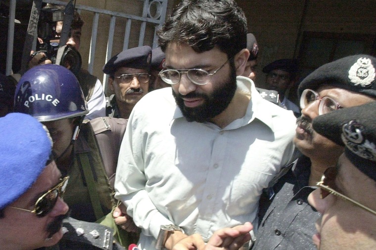 Image: Pakistani police surround a handcuffed Ahmed Omar Saeed Sheikh as he comes out of a court in Pakistan's port city of Karachi
