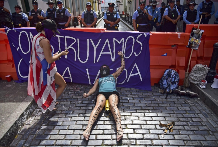 The activist group, Feminist Collective in Construction, protests near La Fortaleza governor's residence as they demand the declaration of a state of emergency in response to gender-based violence against women in San Juan, Puerto Rico, on Aug. 22, 2019.