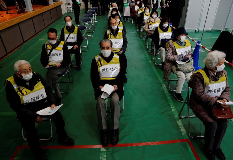 Image: Participants take part in a mock inoculation exercise on Wednesday in Kawasaki, Japan as the country prepares for a Covid-19 vaccination drive. It's the last major industrial country to start vaccinations.