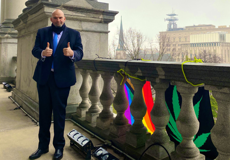 Lieutenant Governor John Fetterman, D - Pa., stands on the balcony outside his office near a LGBTQ and marijuana flags in Pa., on Jan 26, 2021.
