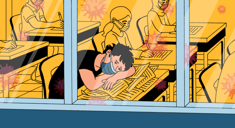 Image: Illustration, seen from outside of school windows, of a student with his head down on a messy desk while wearing a mask, looking forlorn. Other students in masks work at their desks. Coronavirus spores reflect in the windows.