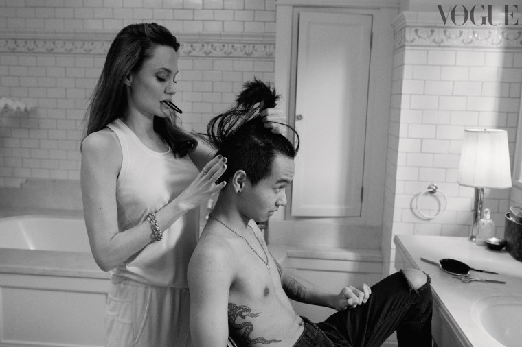 Jolie works on Maddox's hair.