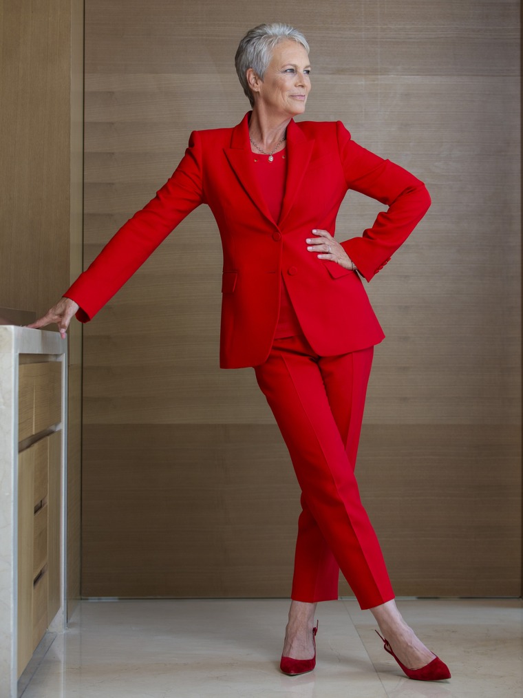 Jamie Lee Curtis poses in a red suit