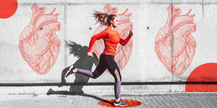 Woman running with heart graffiti on the wall behind her