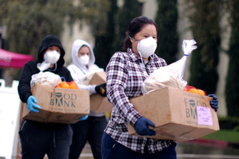 People pick up fresh food at a Los Angeles Regional Food Bank giveaway of 2,000 boxes of groceries, as the spread of the coronavirus disease (COVID-19) continues, in Los Angeles.