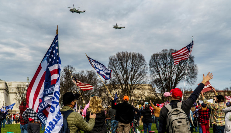 Image: Two helicopters fly over the crowd of Trump supporters on the National Mall in Washington DC