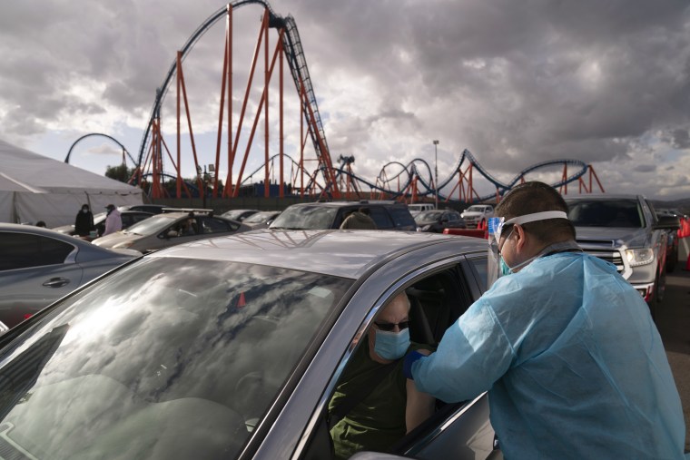 Image: A nurse administers the Covid-19 vaccine at a mass vaccination site in the parking lot of Six Flags Magic Mountain in Valencia, Calif., on Jan. 22, 2021.