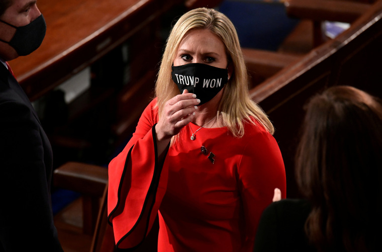 Image: Rep. Marjorie Taylor Greene (R-GA) wears a "Trump Won" face mask as she arrives to take her oath of office as a member of the 117th Congress in Washington