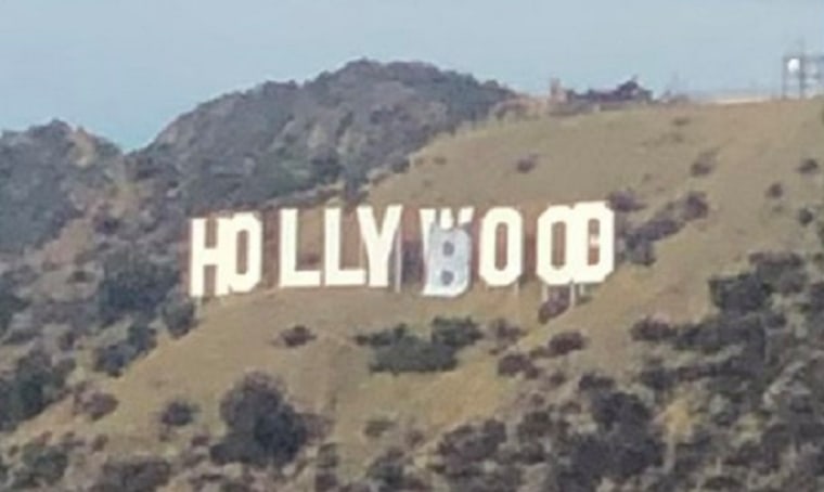 A half-dozen people were taken into custody on Feb. 1, 2021, shortly after police said they altered the "w" and "d" of the Hollywood sign to make the famous landmark read "Hollyboob."