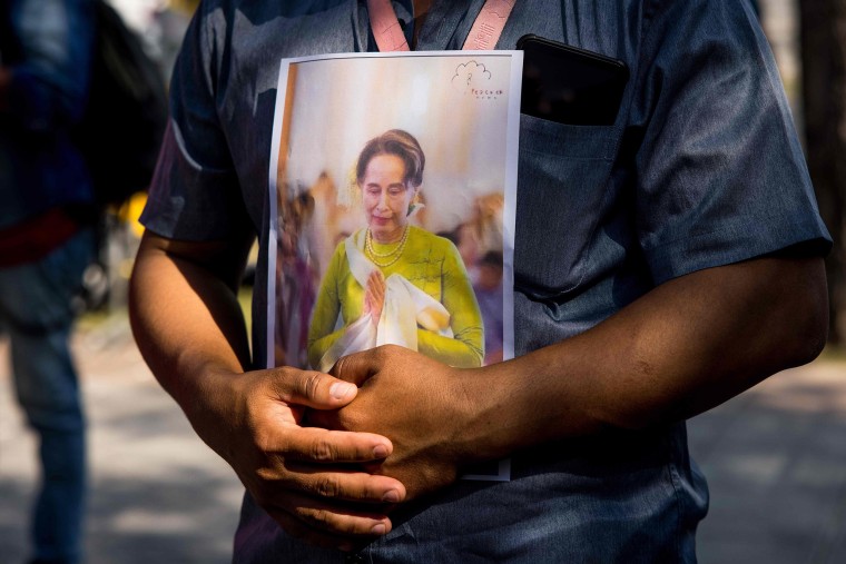 Image: A protester holds an image of Aung San Suu Kyi outside the United Nations building in Bangkok