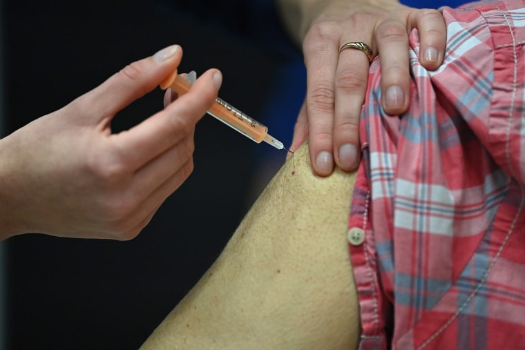 Image: A patient receives an injection of the Oxford/AstraZeneca Covid-19 vaccine at the vaccination centre set up inside Brighton Centre in Brighton, southern England