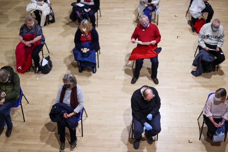 Image: People wait to receive a Covid-19 vaccine in the Winding Wheel Theatre, Chesterfield, Britain