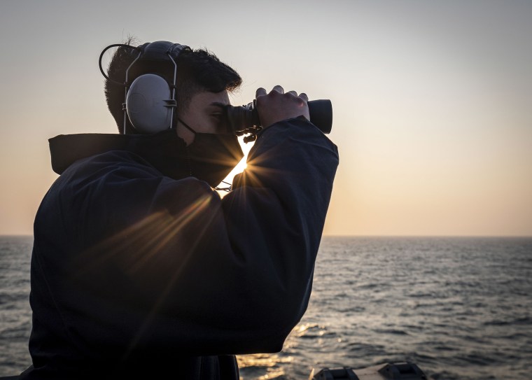 Image: Seaman Frank Medina, from Dallas, Texas, scans the horizon while standing on the bridge wing aboard the Arleigh Burke-class guided-missile destroyer USS John S. McCain