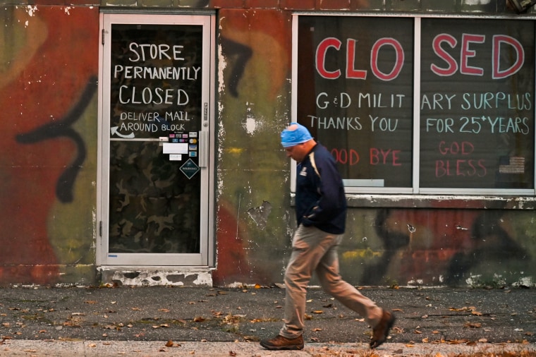 A pedestrian walks past a store that closed due to the pandemic in 2020
