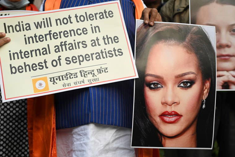 Image: United Hindu Front activists hold a placard and pictures of Barbadian singer Rihanna during a demonstration in New Delhi on Feb. 4, 2021, after they made comments on social media about mass farmers' protests in India.