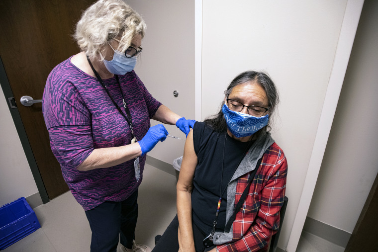 Betty Frogg of the Cherokee Nation receives a Covid-19 vaccine.
