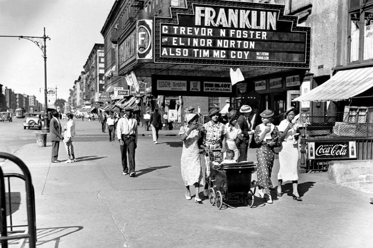 Image: Pedestrians on a summer day in Harlem, N.Y., in 1935.