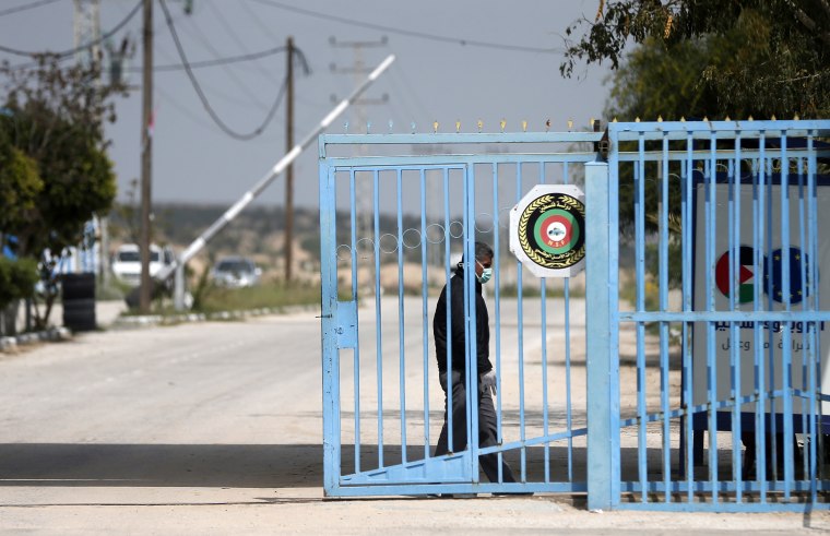 Image: A Palestinian health ministry officer stands at the gate of the Erez crossing with Israel near Beit Hanun in the northern Gaza Strip.