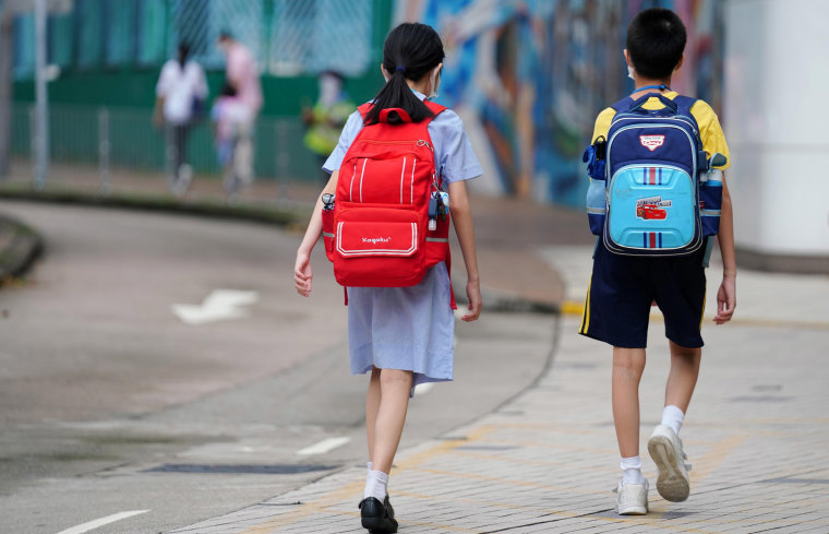 Image: Students wearing face masks walk to school on the first day of the reopening on Sept. 29, 2020 in Hong Kong, China.