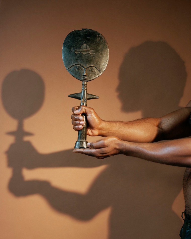 John Edmonds' 2019 photograph "Holding a sculpture (from the Ashanti)" is part of the exhibition "A Sidelong Glance" at the Brooklyn Museum in New York through Aug. 8, 2021.
