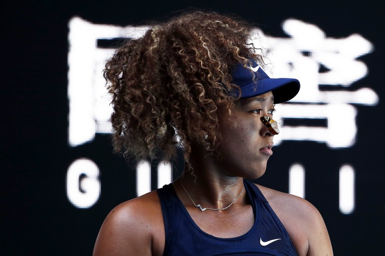 Naomi Osaka of Japan looks on as a butterfly lands on her face.