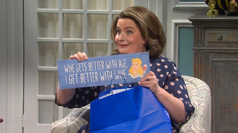 Aidy Bryant shows off her sign in the "Birthday Party" sketch on "SNL."