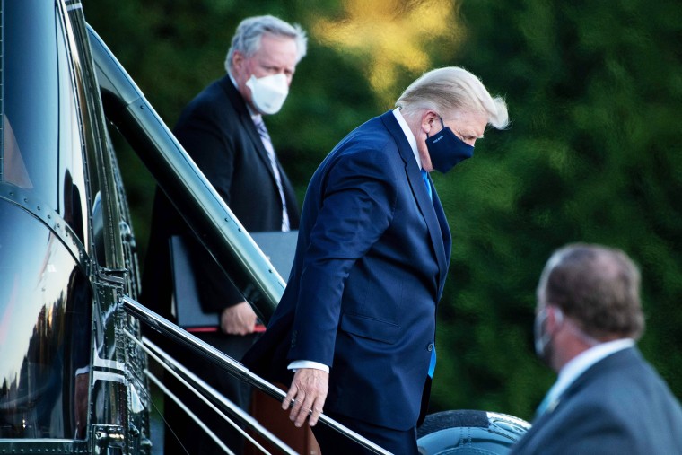 White House Chief of Staff Mark Meadows, left, watches as President Donald Trump walks off Marine One while toward Walter Reed Medical Center in Bethesda, Md., on Oct. 2, 2020.