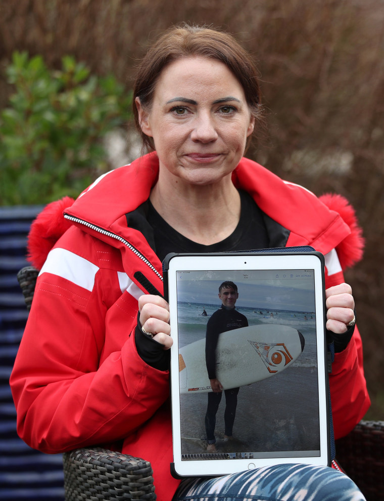 Image: Sally Flavill shows a photograph of her nephew Joseph Flavill, who has awoken from a coma with no knowledge of the Covid-19 pandemic after he was injured in a car accident in March 2020