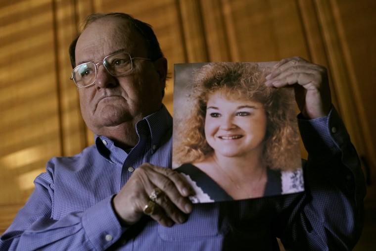 Mortuary owner Brian Simmons holds a photo of his daughter, Rhonda Ketchum, on Jan. 28, 2021, in Springfield, Mo. Ketchum died before Christmas of Covid-19,