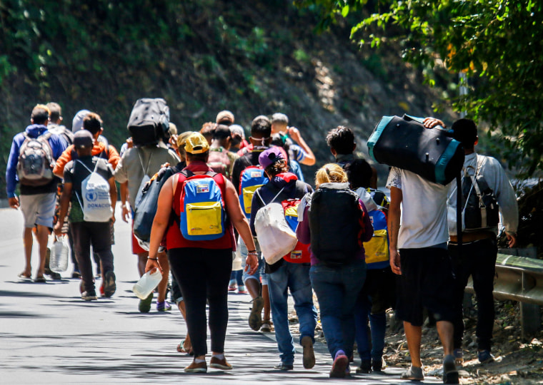 Image: Venezuelan migrants walk along a highway in Colombia