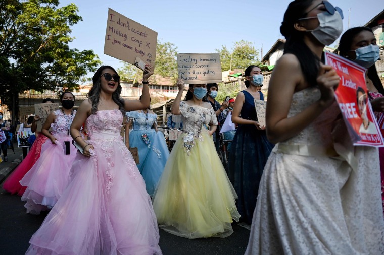 Image: Myanmar women in wedding gowns hold signs during a demonstration against the military coup in Yangon on Wednesday.