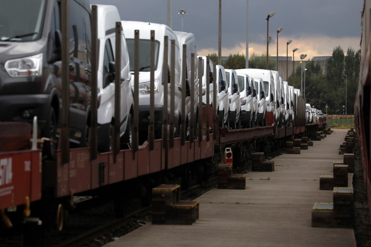 Image: Ford Transit vans sit loaded on a transporter train at the Ford Motor Co.s engine assembly plant in Dagenham, U.K.