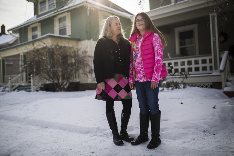 Susan McLaughlin with her daughter Izzy Burgeson outside their home in Delaware, Ohio.